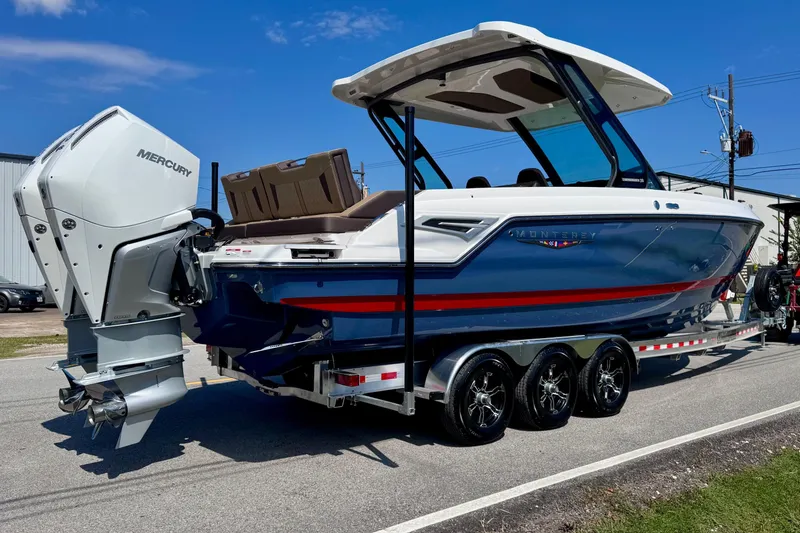 Slide: The Image of 2026 Monterey Elite 30 OB boat with Mercury outboard engines on a trailer. - 4