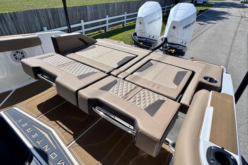 Slide: The Image of 2026 Monterey Elite 30 OB boat with luxurious seating and dual Mercury outboard engines. - 9