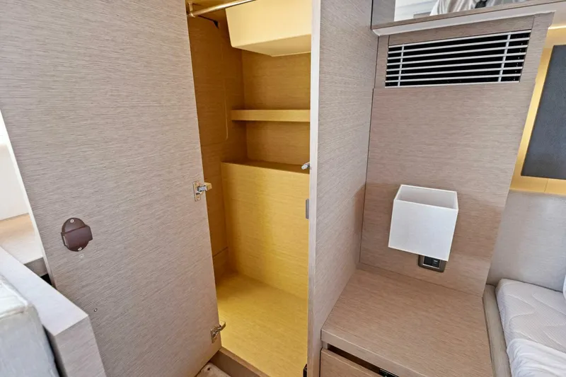 Slide: The Image of Interior closet space on 2023 Prestige 460 Flybridge yacht, featuring modern wood finish. - 28