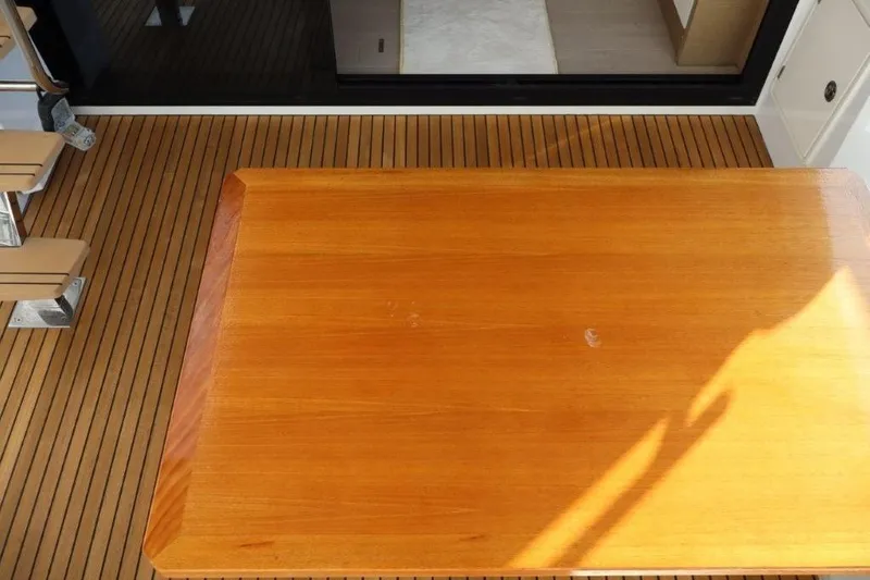 Slide: The Image of Teak deck and table on 2023 Prestige 460 yacht, showcasing luxury marine craftsmanship. - 42