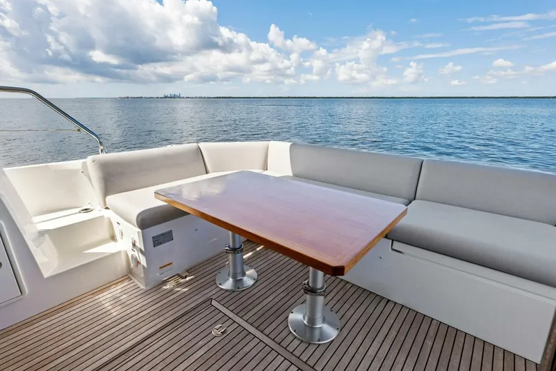 Slide: The Image of Prestige 460 Flybridge 2023 yacht deck with seating and ocean view. - 43