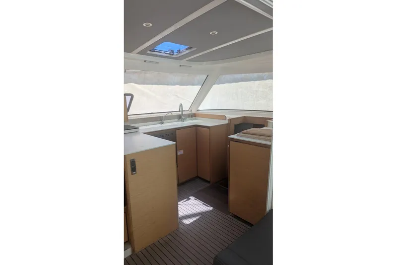 Slide: The Image of Interior of 2016 Nautitech 40 Open catamaran, featuring modern kitchen and sleek design. - 13