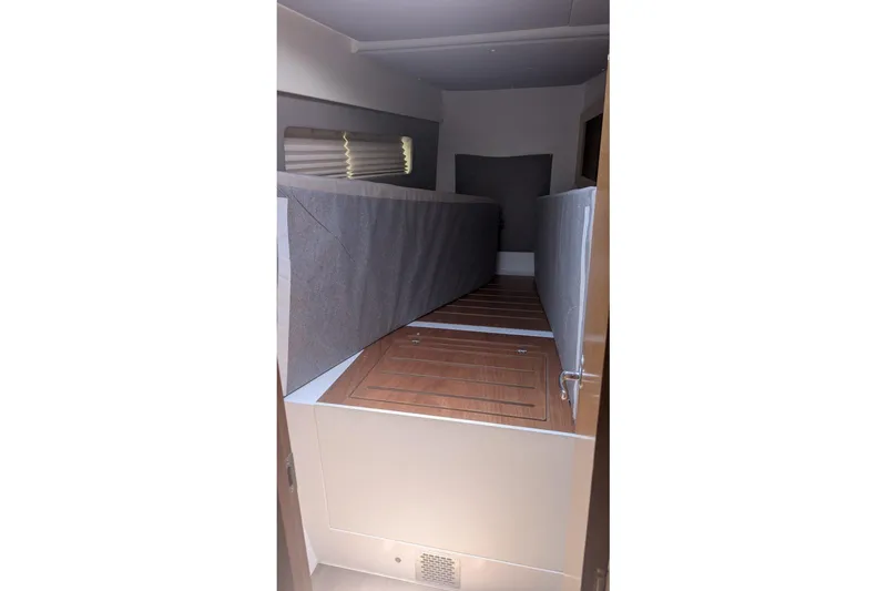 Slide: The Image of Interior cabin of 2016 Nautitech 40 Open catamaran with wooden flooring and cushioned seating. - 17