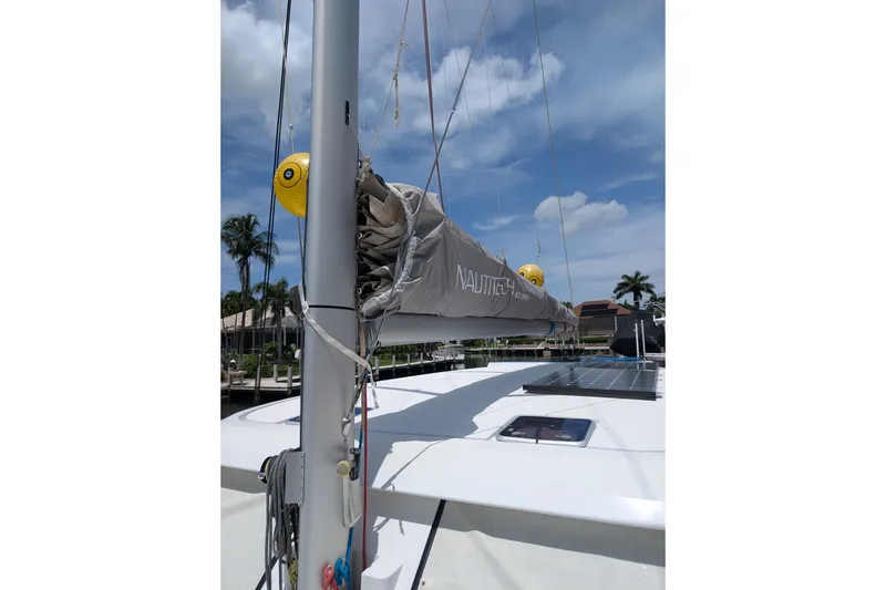 Slide: The Image of Nautitech 40 Open 2016 catamaran with solar panels and mast, docked under blue sky. - 29