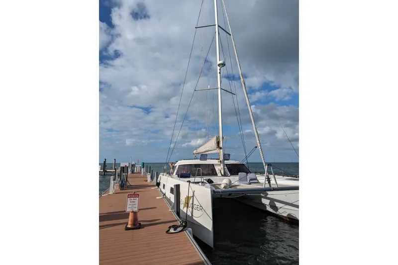 Slide: The Image of 2016 Nautitech 40 Open catamaran docked under a cloudy sky. - 3