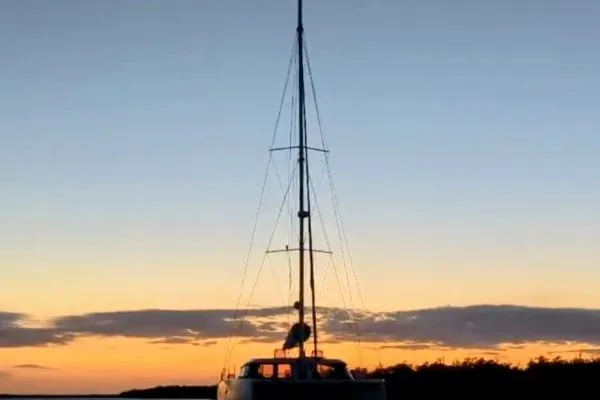 Slide: The Image of Sailboat Nautitech 40 Open 2016 at sunset, silhouetted against a colorful sky. - 33