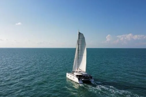 Slide: The Image of Sailing catamaran Nautitech 40 Open 2016 on open sea under clear blue sky. - 37