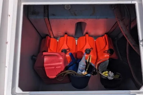 Slide: The Image of Storage compartment on a 2016 Nautitech 40 Open with fuel containers and supplies. - 46