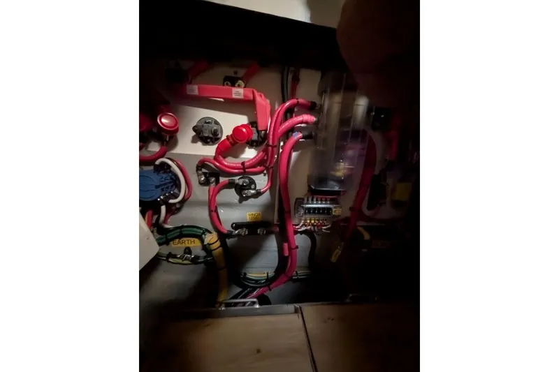 Slide: The Image of Electrical system of a 2016 Nautitech 40 Open catamaran with red and black wiring. - 49