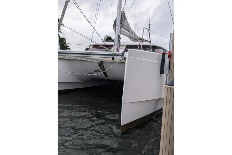 Slide: The Image of 2016 Nautitech 40 Open catamaran docked, showcasing sleek hull design. - 5