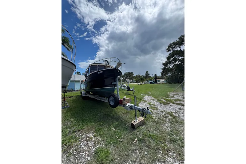 The Image of 2008 Ranger Tugs R-25 Classic boat on trailer under cloudy sky. - 0