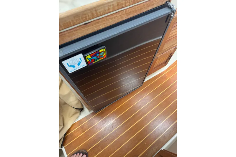 Slide: The Image of 2008 Ranger Tugs R-25 Classic interior with wood flooring and compact refrigerator. - 10