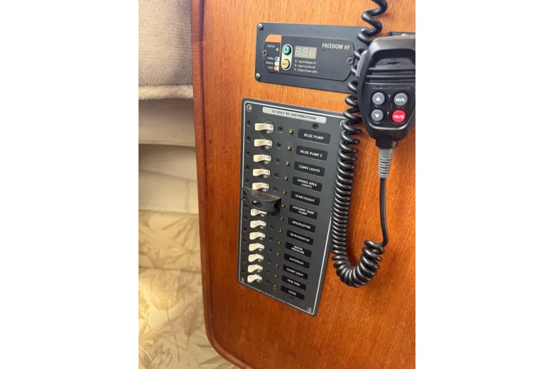 Slide: The Image of Control panel of 2008 Ranger Tugs R-25 Classic with switches and radio handset. - 14