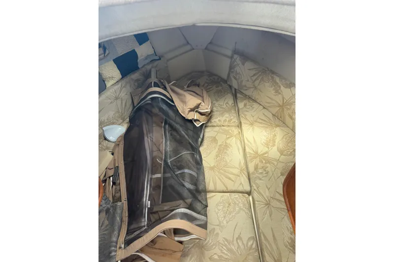 Slide: The Image of 2008 Ranger Tugs R-25 Classic cabin interior with floral upholstery and folded canvas. - 19