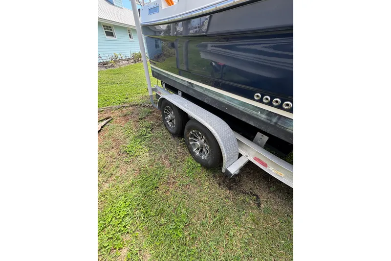 Slide: The Image of 2008 Ranger Tugs R-25 Classic boat on trailer, parked on grass. - 2