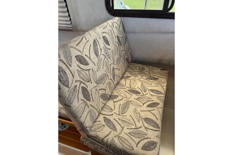 Slide: The Image of 2008 Ranger Tugs R-25 Classic interior with leaf-patterned upholstery. - 9