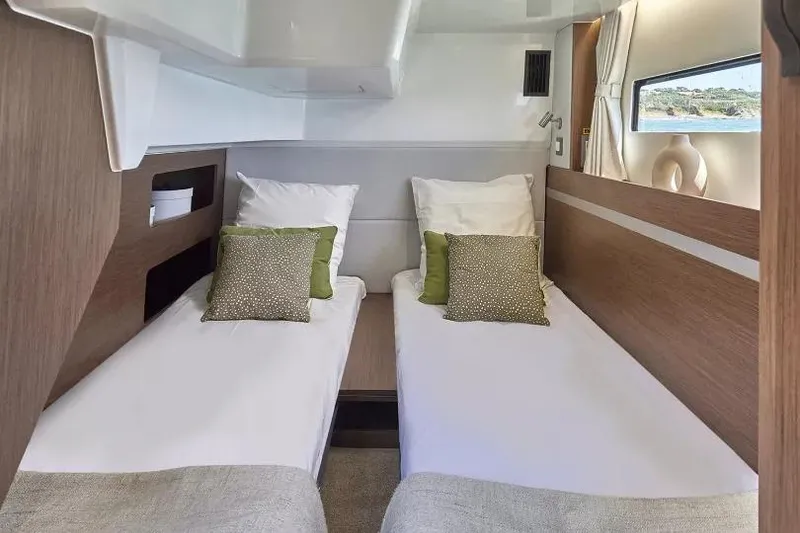 Slide: The Image of Interior cabin of 2026 Beneteau Antares 12 with twin beds and modern decor. - 11