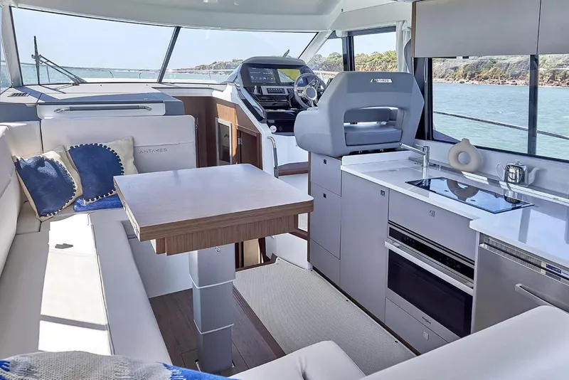 Slide: The Image of Luxurious interior of 2026 Beneteau Antares 12 yacht with modern kitchen and seating area. - 3