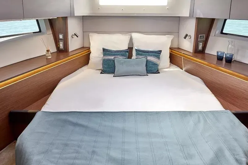 Slide: The Image of Luxurious cabin interior of 2026 Beneteau Antares 12 with elegant bedding and modern design. - 4