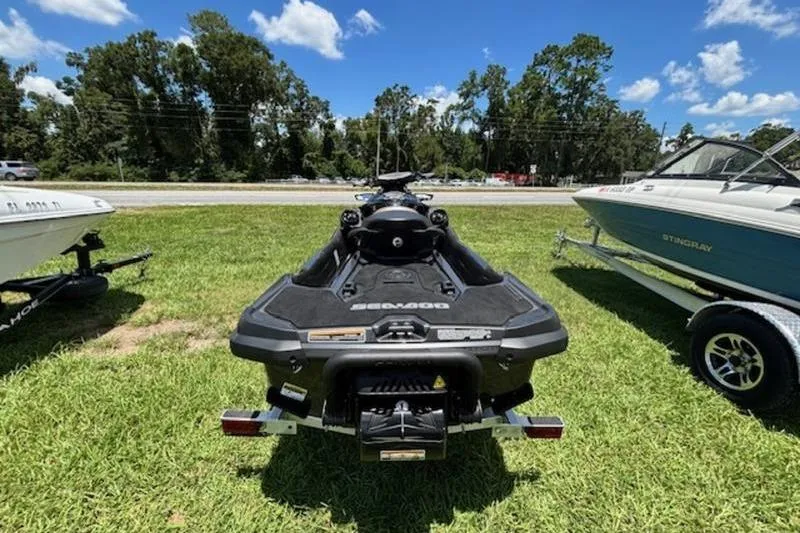 Slide: The Image of 2023 Sea-Doo GTX 170 jet ski on grass, surrounded by boats, under a clear sky. - 4