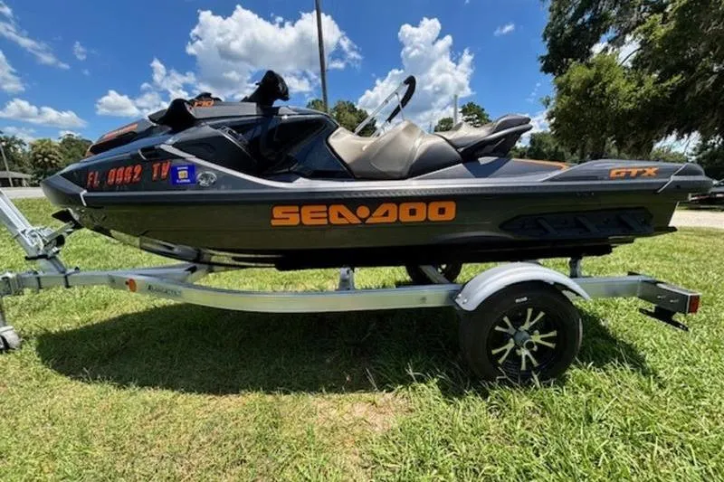 Slide: The Image of 2023 Sea-Doo GTX 170 jet ski on trailer, parked on grass under blue sky. - 5