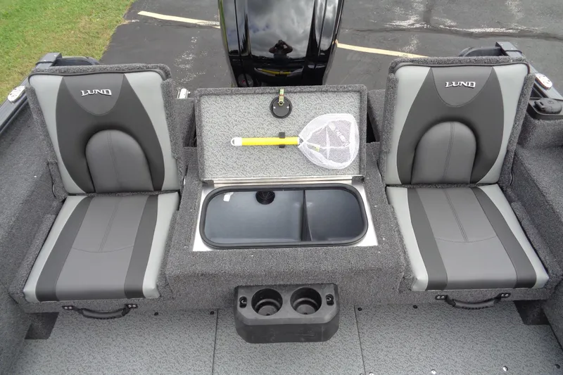 Slide: The Image of 2026 Lund 1675 Adventure SS boat interior with two seats, storage, and fishing net. - 10
