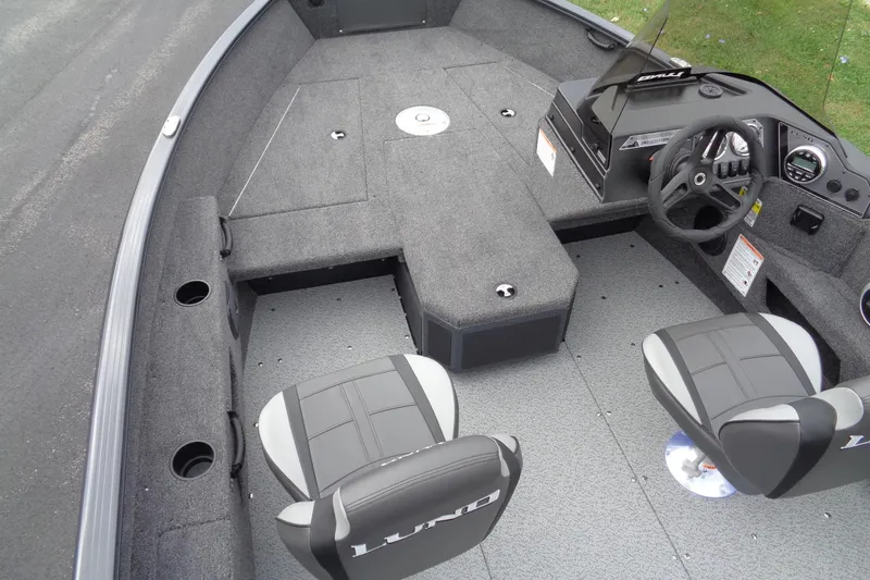 Slide: The Image of 2026 Lund 1675 Adventure SS boat interior with seating and steering console. - 11