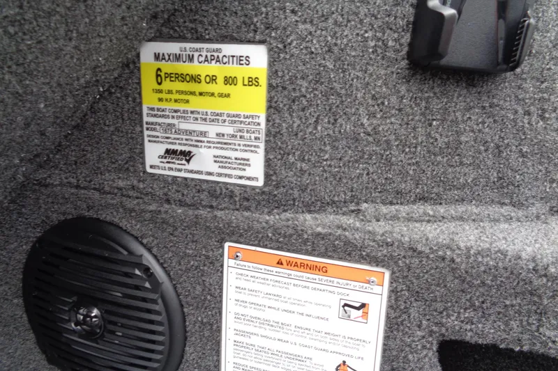 Slide: The Image of 2026 Lund 1675 Adventure SS boat capacity and safety warning labels. - 12