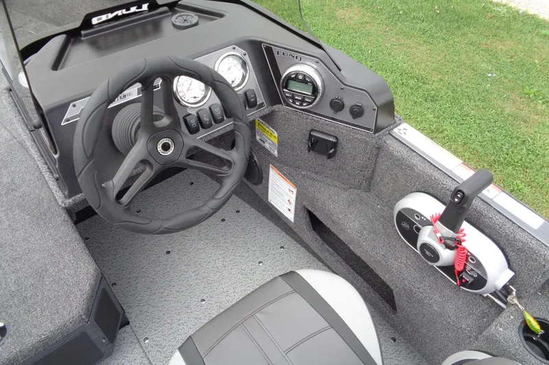 Slide: The Image of Interior view of 2026 Lund 1675 Adventure SS boat cockpit with steering wheel and controls. - 13