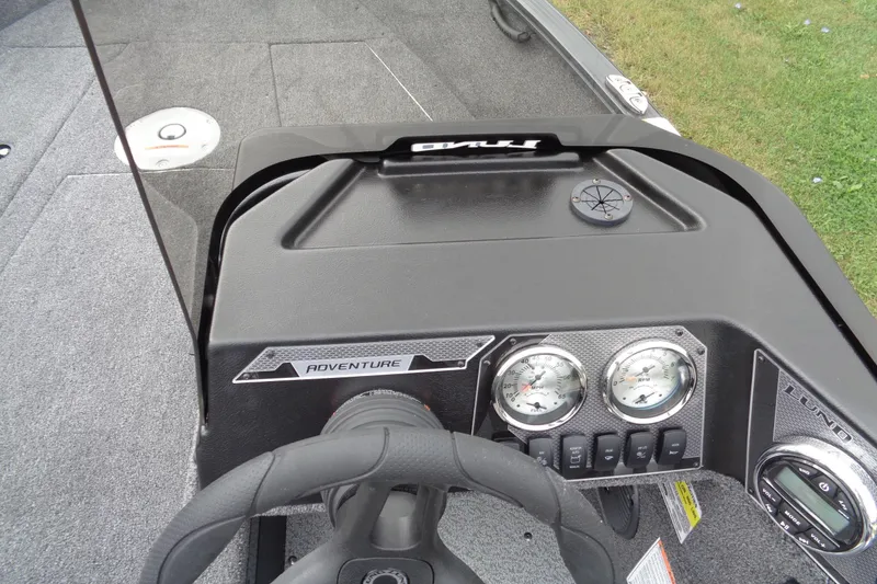 Slide: The Image of 2026 Lund 1675 Adventure SS boat dashboard with steering wheel and gauges. - 14