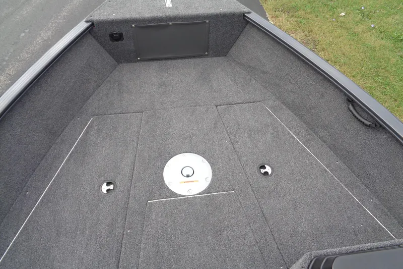 Slide: The Image of 2026 Lund 1675 Adventure SS boat interior with carpeted deck and storage compartments. - 17