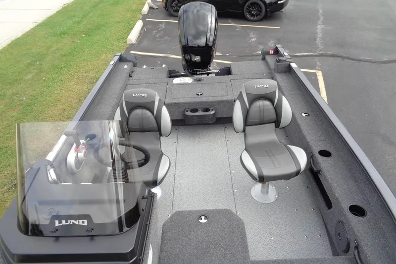 Slide: The Image of 2026 Lund 1675 Adventure SS boat interior with seating and steering console. - 18