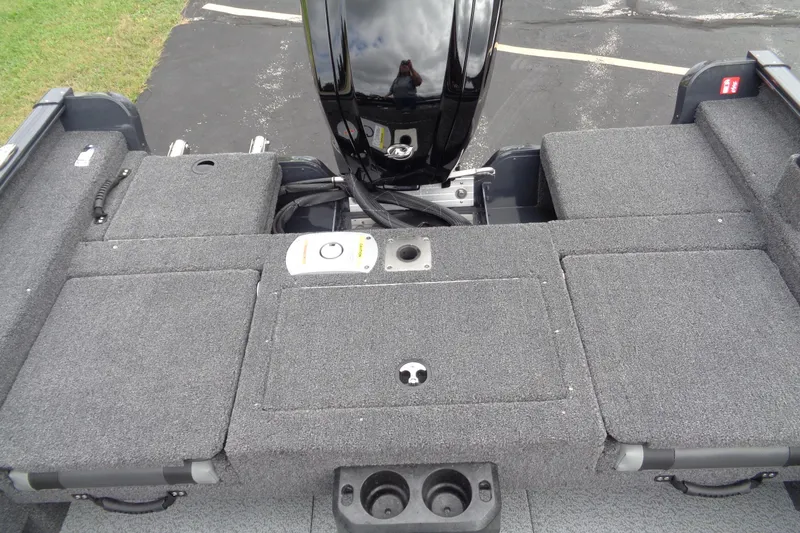 Slide: The Image of 2026 Lund 1675 Adventure SS boat deck with motor, featuring gray carpeted surface. - 9