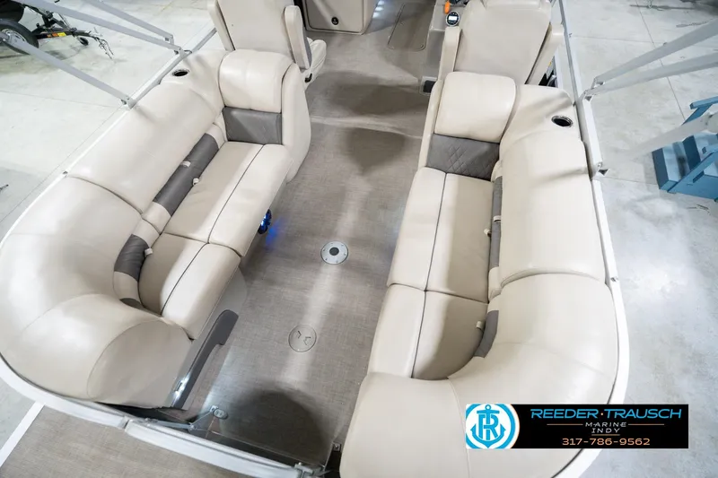 Slide: The Image of 2020 Sun Tracker Party Barge 24 DLX interior with beige seating and spacious layout. - 14