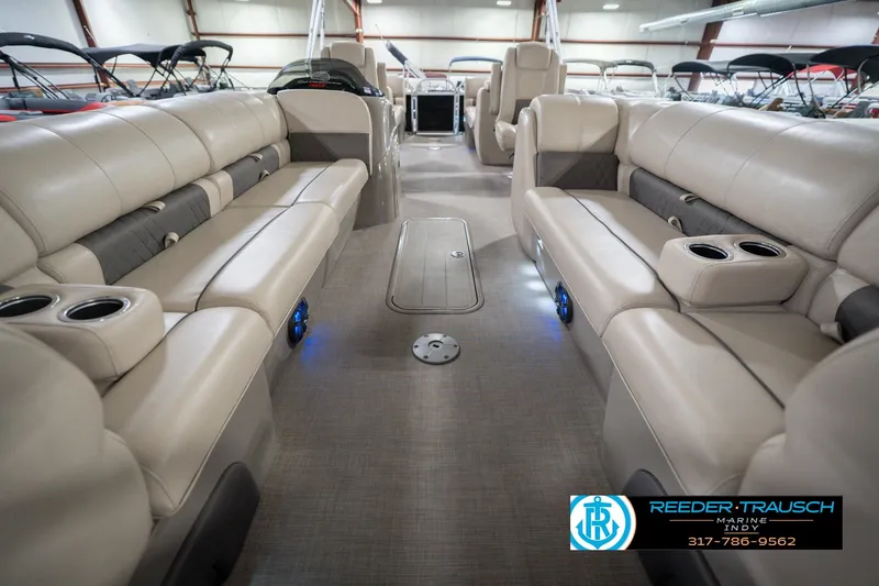 Slide: The Image of Interior of 2020 Sun Tracker Party Barge 24 DLX with beige seating and cup holders. - 16