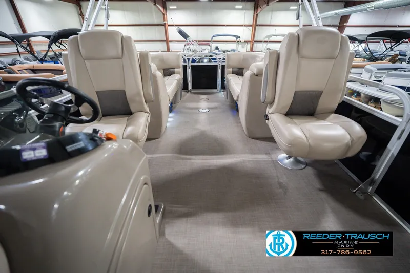 Slide: The Image of Interior of 2020 Sun Tracker Party Barge 24 DLX with beige seating and steering console. - 17