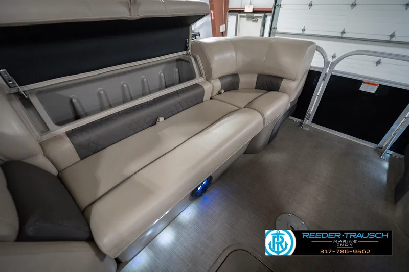 Slide: The Image of 2020 Sun Tracker Party Barge 24 DLX interior seating with storage compartment. - 25