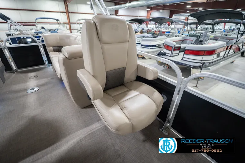 Slide: The Image of 2020 Sun Tracker Party Barge 24 DLX with beige seating in a showroom. - 27
