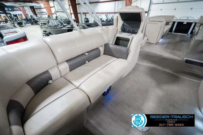 Slide: The Image of 2020 Sun Tracker Party Barge 24 DLX interior with beige seating and storage compartment. - 31