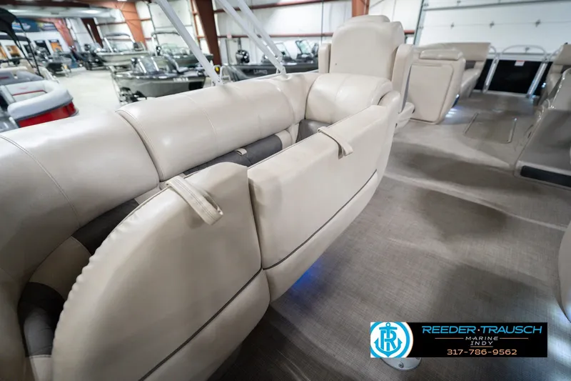 Slide: The Image of 2020 Sun Tracker Party Barge 24 DLX interior with beige seating in showroom. - 32