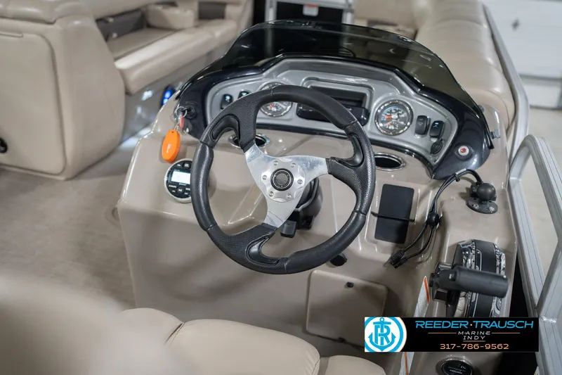 Slide: The Image of 2020 Sun Tracker Party Barge 24 DLX steering console with gauges and controls. - 34