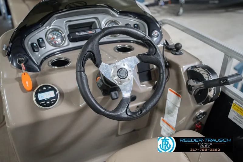 Slide: The Image of 2020 Sun Tracker Party Barge 24 DLX steering console with controls and gauges. - 35