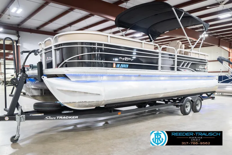 Slide: The Image of 2020 Sun Tracker Party Barge 24 DLX pontoon boat on trailer in showroom. - 4