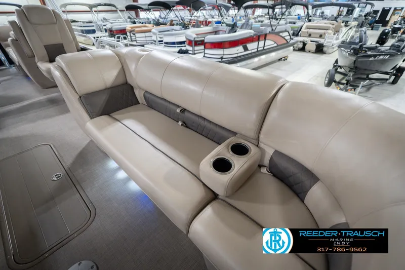 Slide: The Image of 2020 Sun Tracker Party Barge 24 DLX interior with beige seating and cup holders. - 47