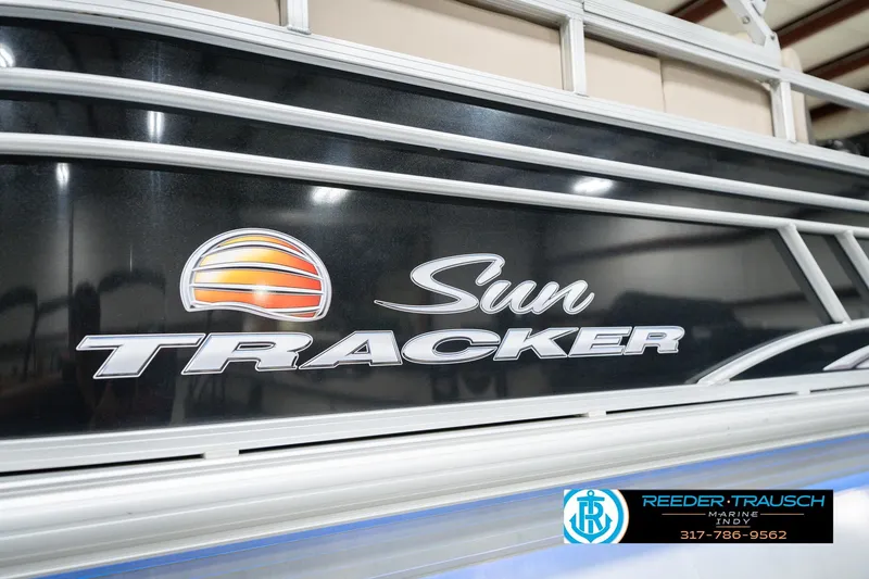 Slide: The Image of 2020 Sun Tracker Party Barge 24 DLX logo on boat exterior with dealership branding. - 57