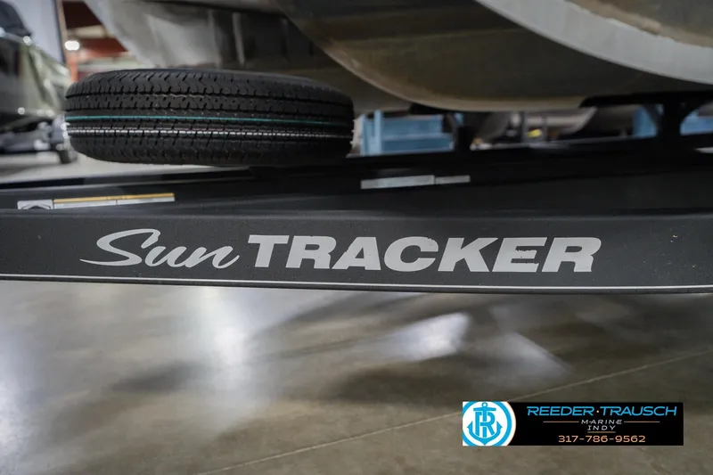 Slide: The Image of 2020 Sun Tracker Party Barge 24 DLX trailer with visible tire and branding. - 60