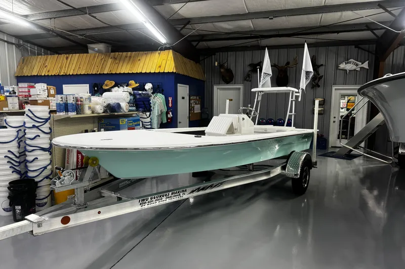 Slide: The Image of 2026 Mitzi Skiffs 17 Tournament boat in showroom, featuring sleek design and modern equipment. - 4