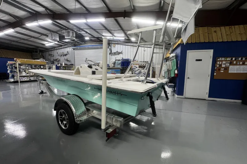 Slide: The Image of 2026 Mitzi Skiffs 17 Tournament boat in showroom with marine supplies. - 5