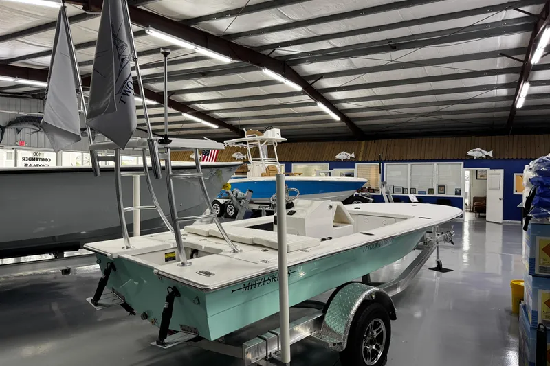 Slide: The Image of 2026 Mitzi Skiffs 17 Tournament boat displayed in a showroom on a trailer. - 7