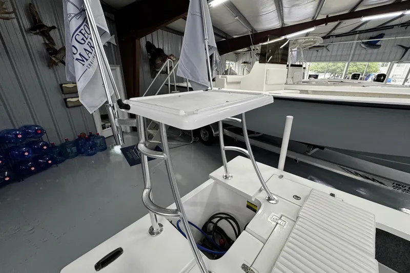 Slide: The Image of 2026 Mitzi Skiffs 17 Tournament boat interior with seating and storage in showroom. - 9